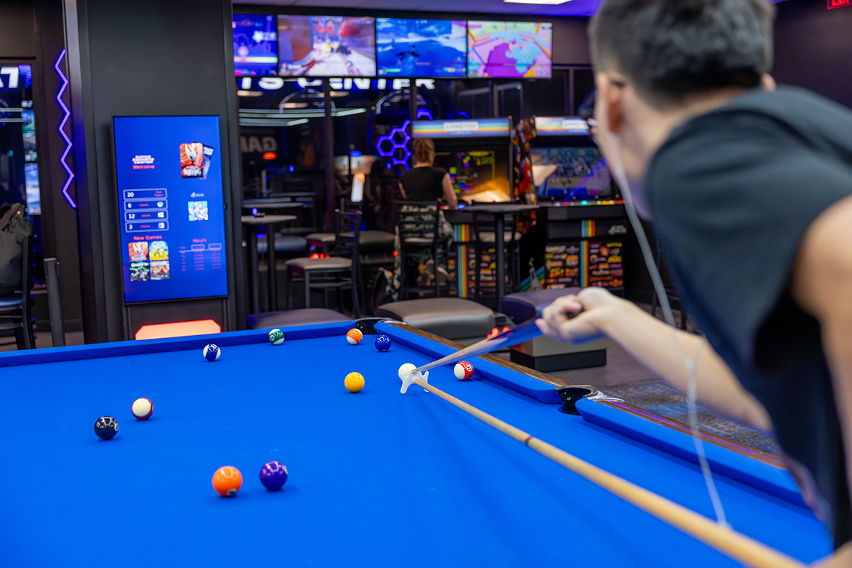 Participants playing billiards at the UF Reitz Union Game Room