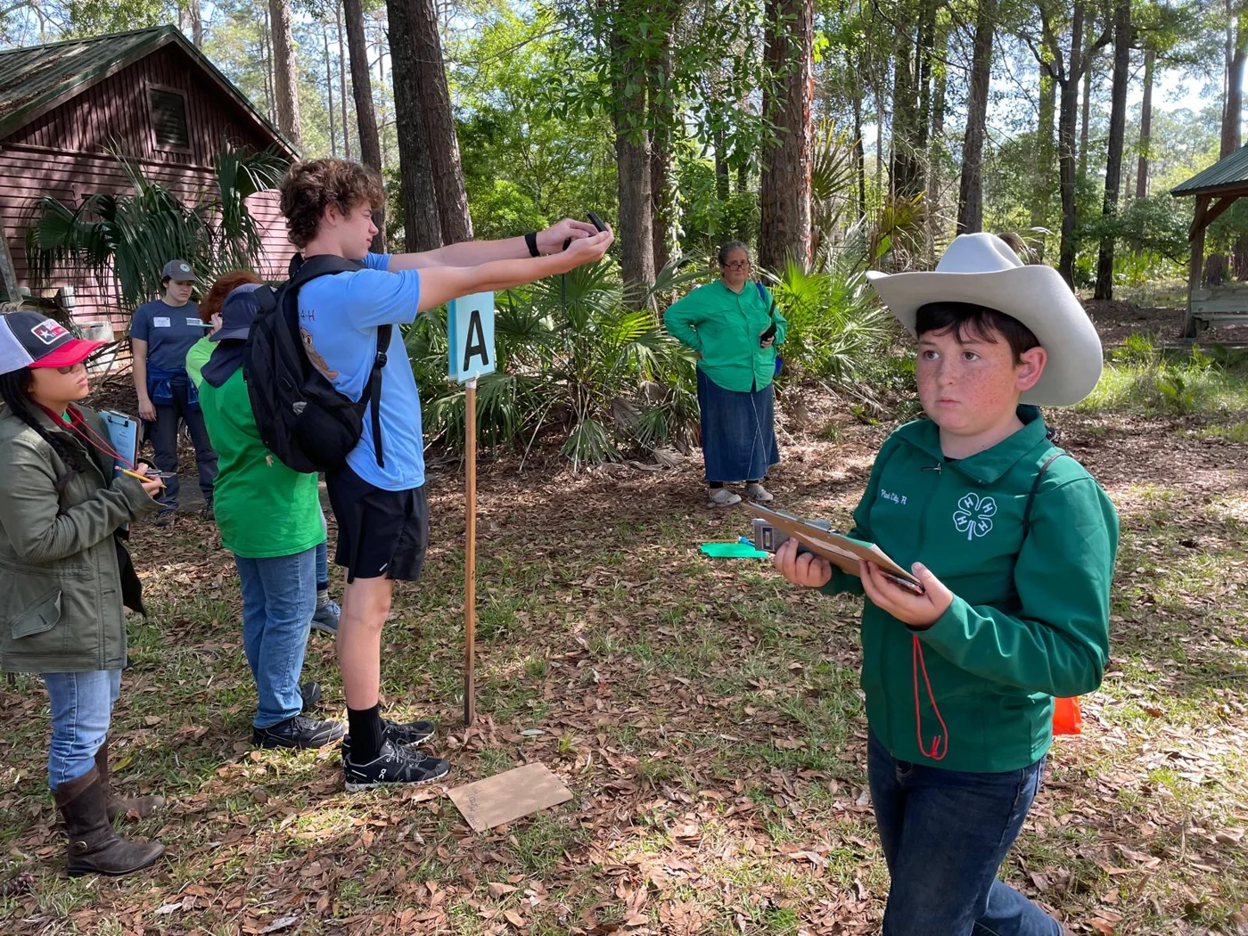 Practicing navigation skills during a 4-H forestry activity.