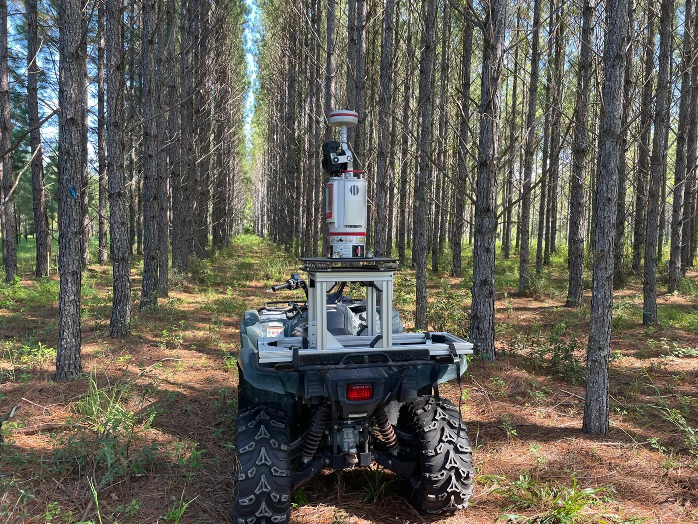 RIEGL VZ-400i mounted on an ATV in a pine forest